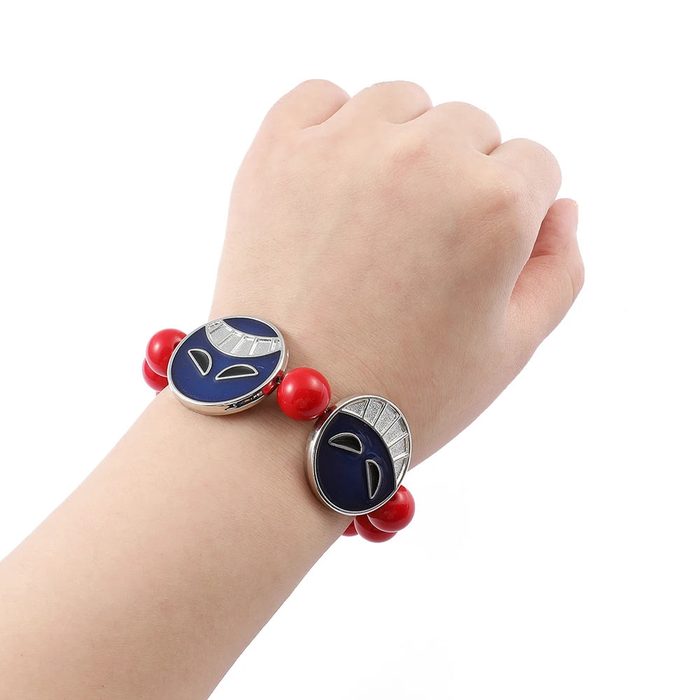 Bracelet with blue and red beads on a wrist against a white background
