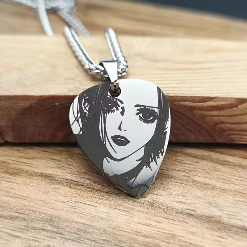 Pendant with a black and white illustration of a face on a wooden surface