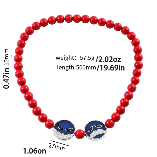 Red beaded bracelet with blue and silver charms on a white background