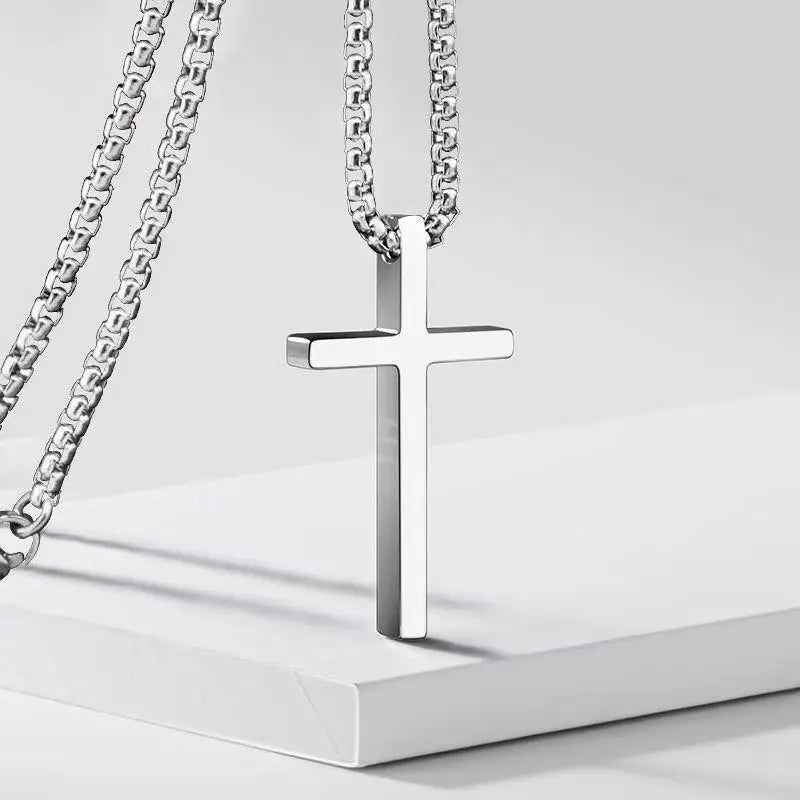 Silver cross necklace on a white background