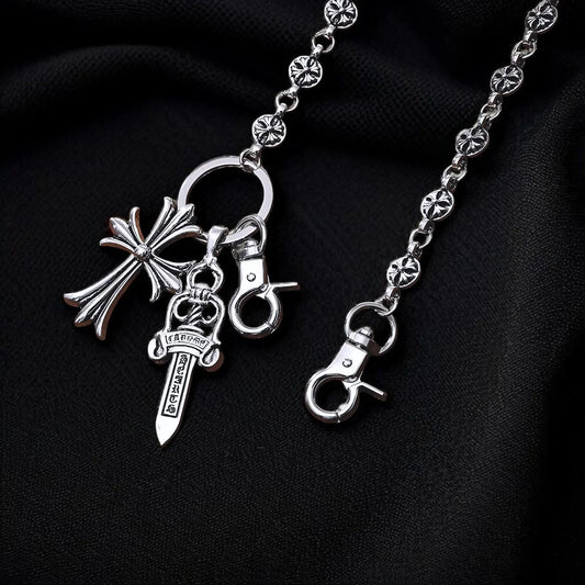 Silver keychain with various charms on a black background