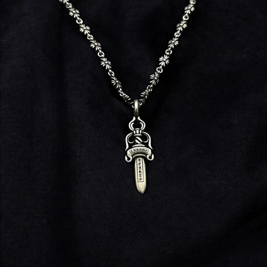 Silver necklace with a pendant on a black background