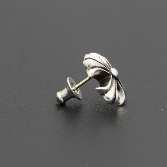 Silver leaf-shaped earring on a dark gray background