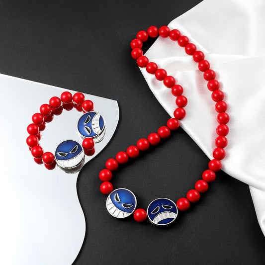 Red beaded necklace with blue and silver pendant on a black and white background
