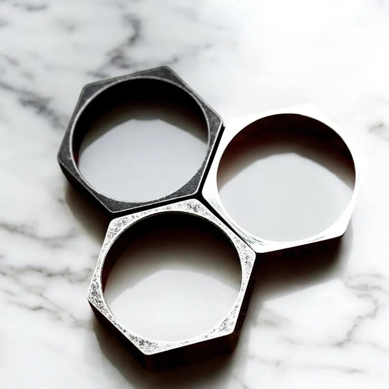 Hexagonal ring with diamond accents on a marble background