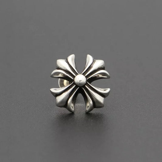 Silver floral-patterned earring on a dark gray background